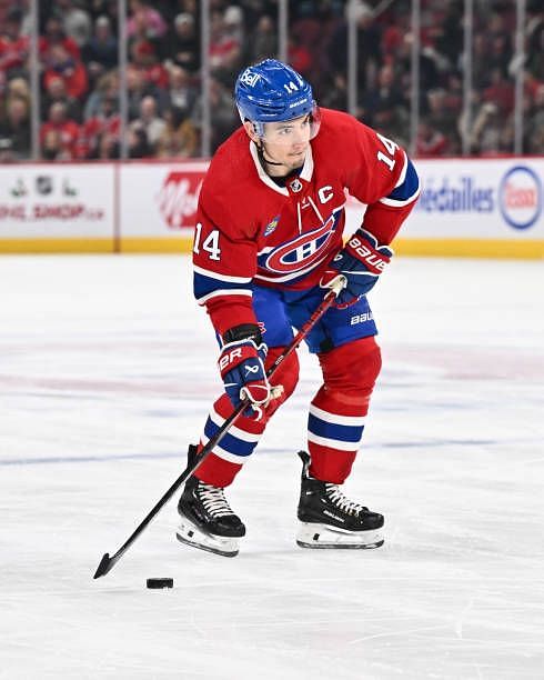 Nick Suzuki of the Montreal Canadiens skates the puck during the second period against the Los Angeles Kings at the Bell Centre on December 7, 2023...