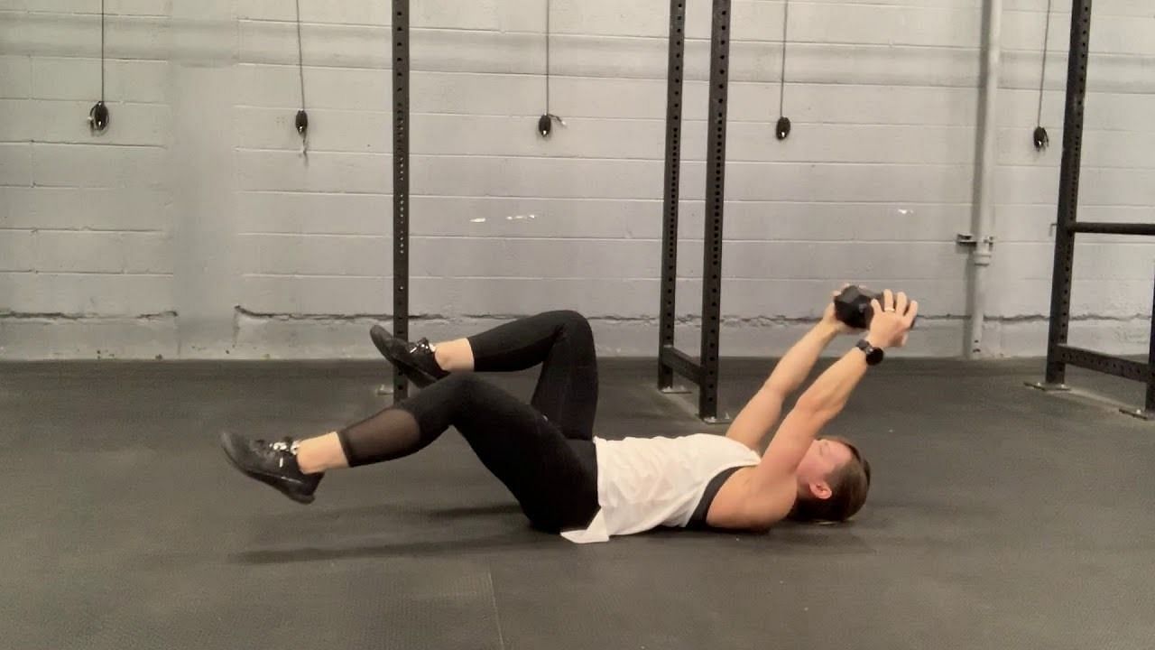 Weighted dead bug exercise (Image via YouTube/Shift Human Performance)