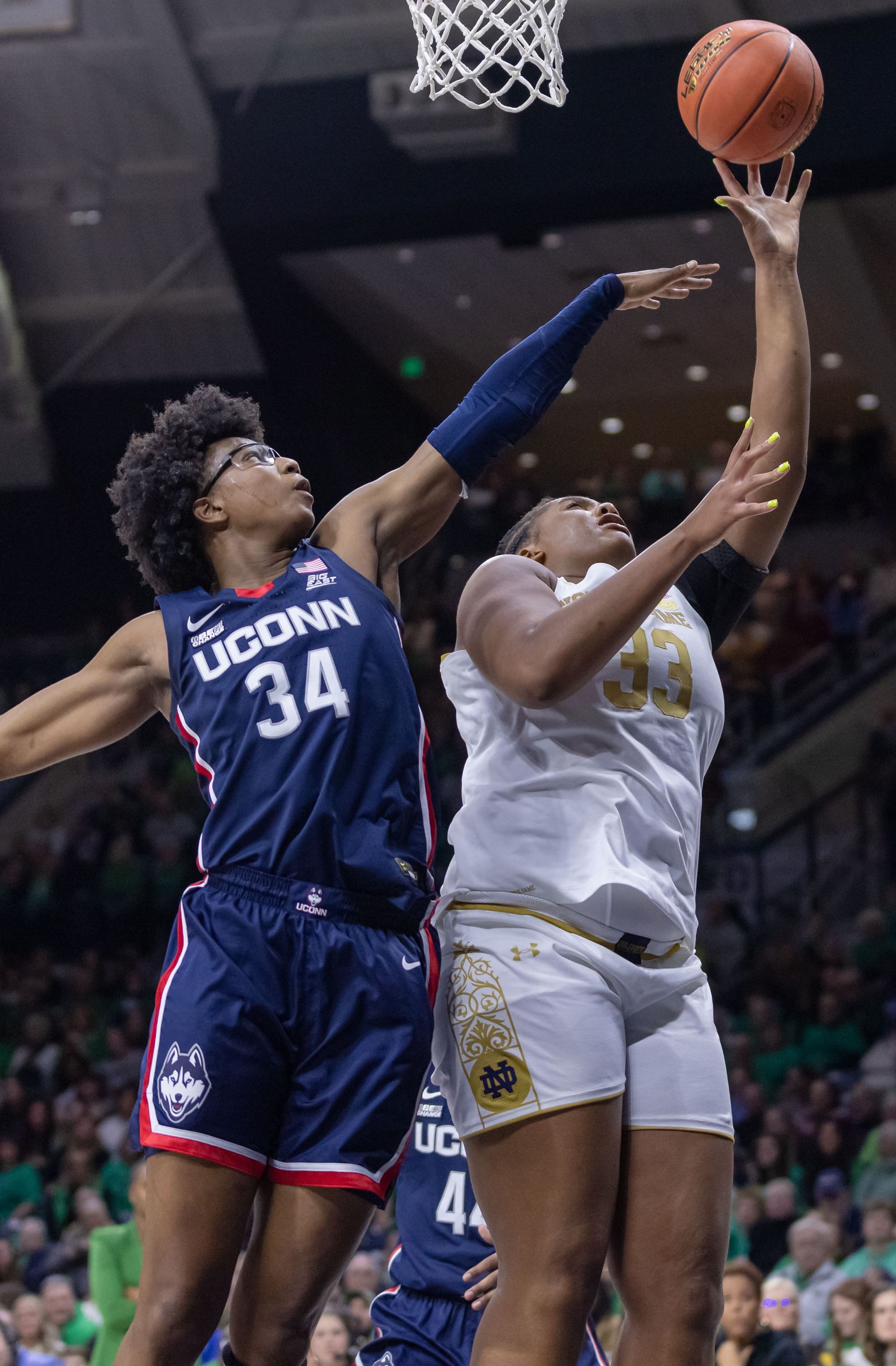 Connecticut v Notre Dame: SOUTH BEND, IN - DECEMBER 04: Lauren Ebo #33 of the Notre Dame Fighting Irish shoots the ball against Ayanna Patterson #34 of the UConn Huskies during the second half at Joyce Center on December 4, 2022 in South Bend, Indiana. (Photo by Michael Hickey/Getty Images)