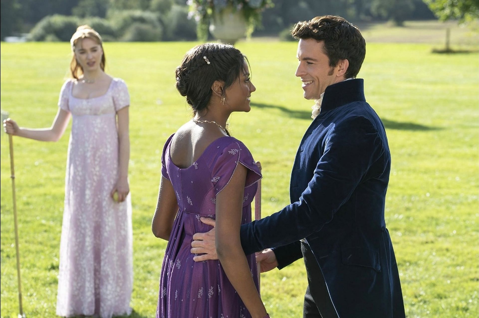 Jonathan Bailey, Phoebe Dynevor, and Simone Ashley in a scene from Bridgerton (Image via IMDb)