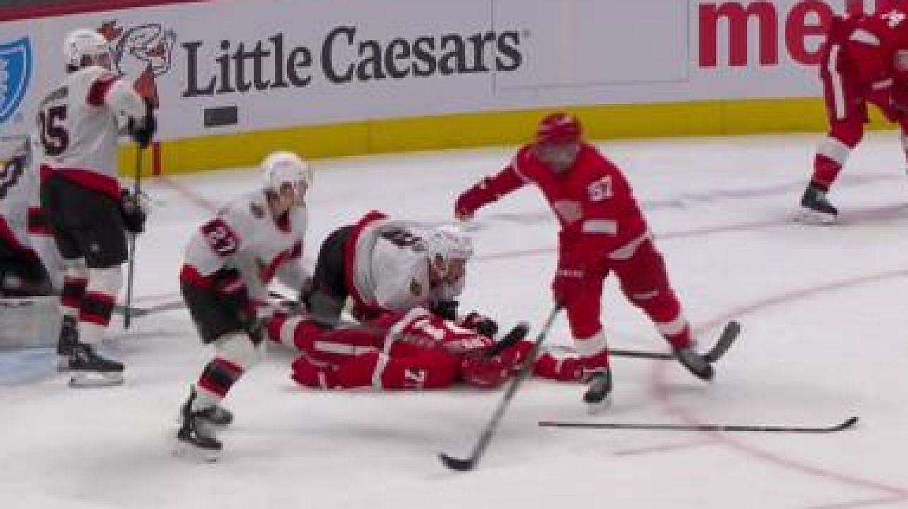 Dylan Larkin on the ice motionless after a hit from teh Ottawa Senators