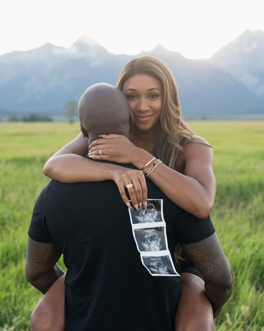 Taylor holding the sonogram with her husband John in July. (Maria Taylor/IG)