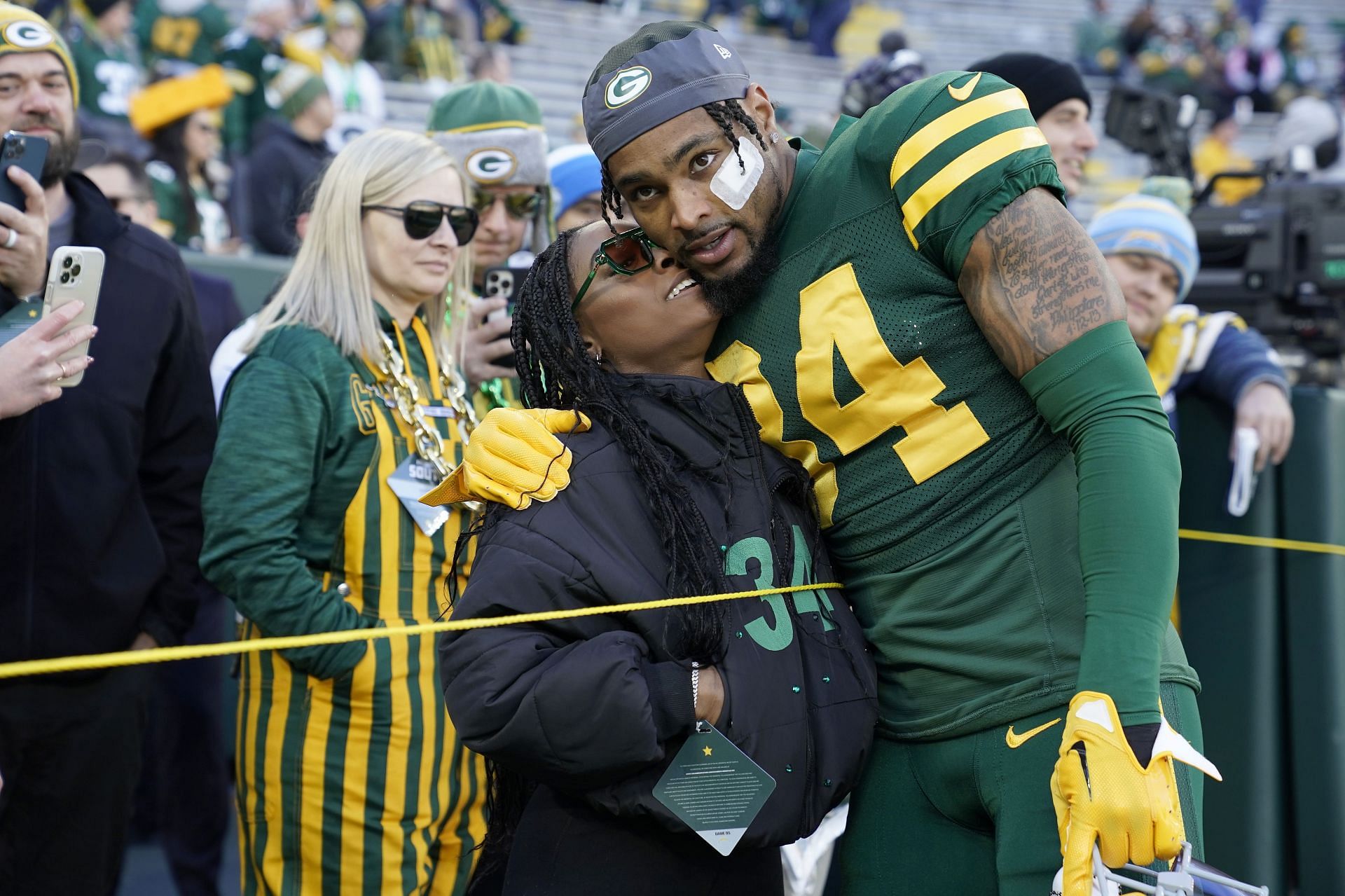 Jonathan Owens of the Green Bay Packers meets with his wife Simone Biles before the game against the Los Angeles Chargers at Lambeau Field on November 19, 2023, in Green Bay, Wisconsin.
