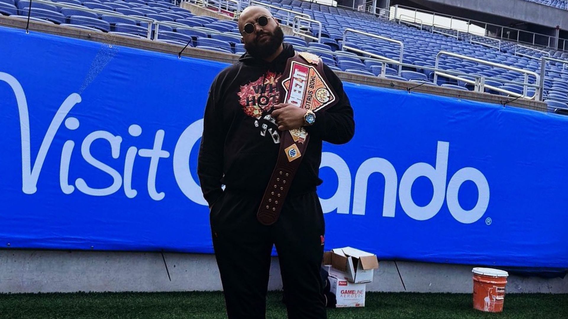 Former WWE mainstay and NFL player AJ Francis poses with the Cheez-It Citrus Bowl MVP belt. (Image credit: AJ Francis