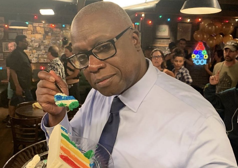 An image of Andre Braugher posing with a vibrant cake (Image via Instagram/@daveyksamuels)