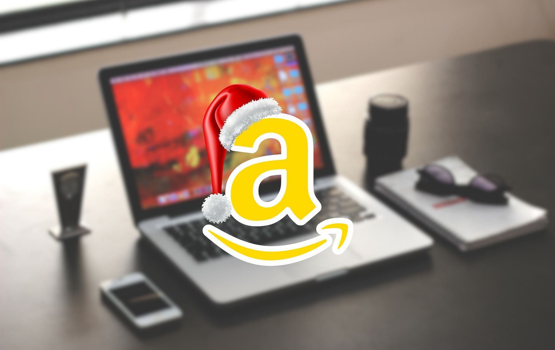 Image showing Amazon logo with a laptop and a few other equipments in the background