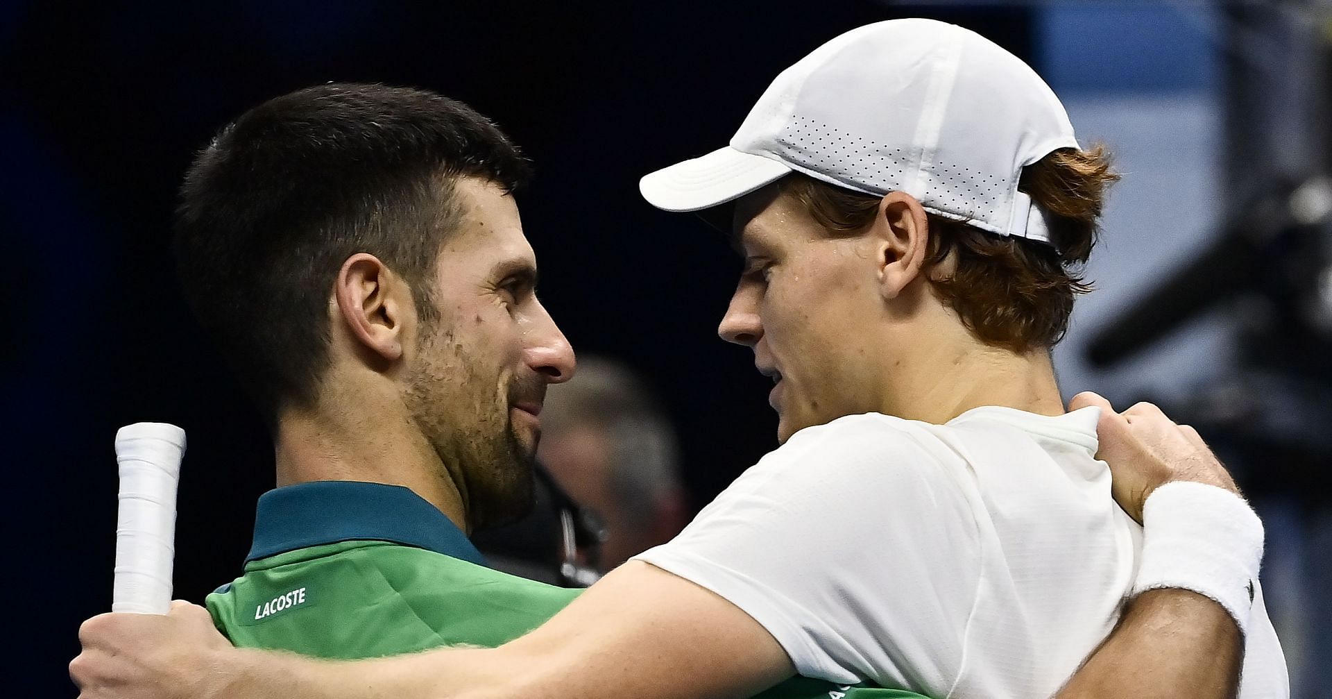 Novak Djokovic and Jannik Sinner embrace after their round-robin match at the ATP Finals