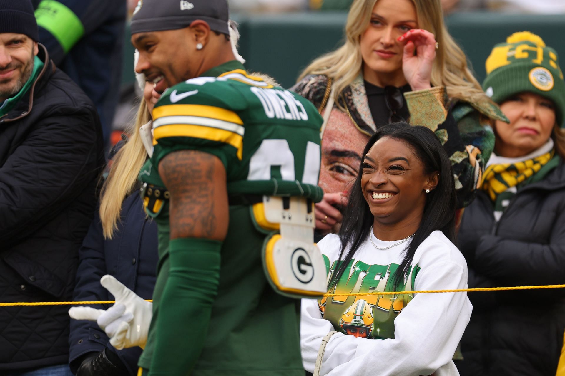 Jonathan Owens of the Green Bay Packers laughs with his wife, Simone Biles, before the game against the Minnesota Vikings at Lambeau Field on October 29, 2023, in Green Bay, Wisconsin.