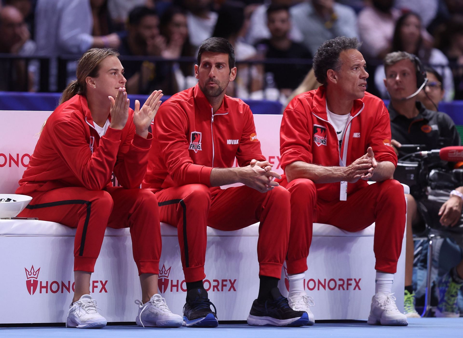 Aryna Sabalenka and Novak Djokovic (L) cheer teammate Paula Badosa during World Tennis League 2022