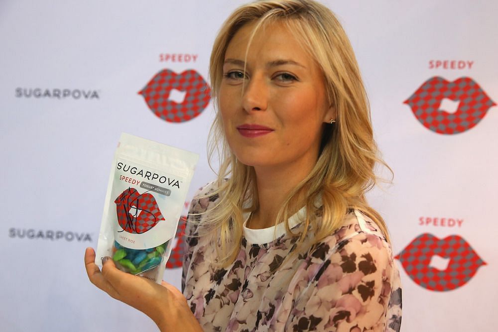 Maria Sharapova poses with a Sugarpova packet at a press conference