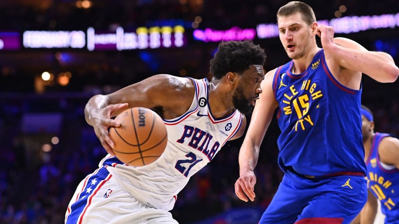 Joel Embiid attempts to drive against Nikola Jokic in this bit of NBA action.