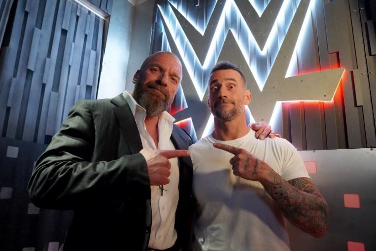CM Punk with WWE COO Triple H after his return