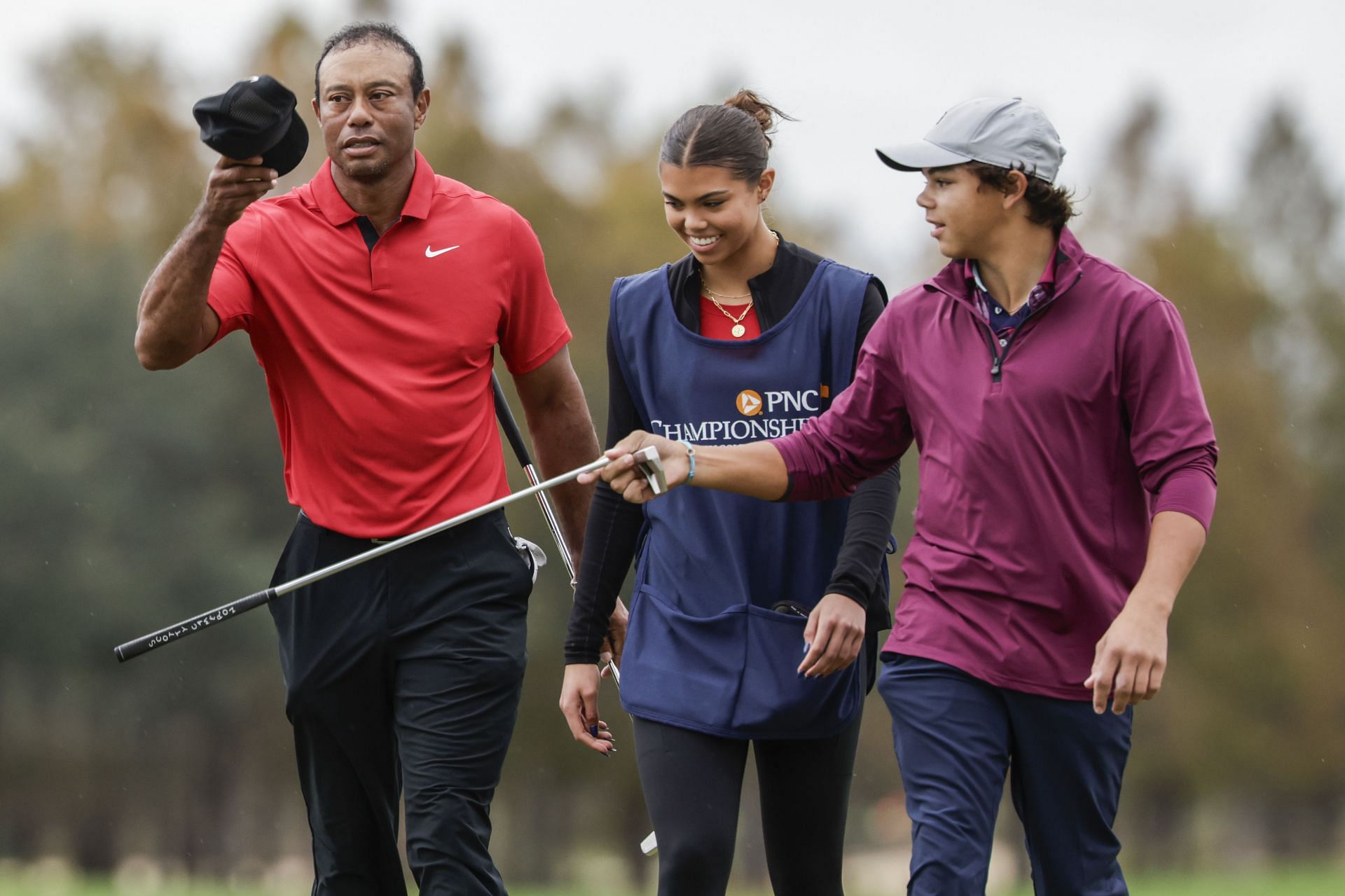 Tiger Woods, left; daughter Sam, center; and son Charlie, right; during the final round of the PNC Championship (Image via AP Photo/Kevin Kolczynski)
