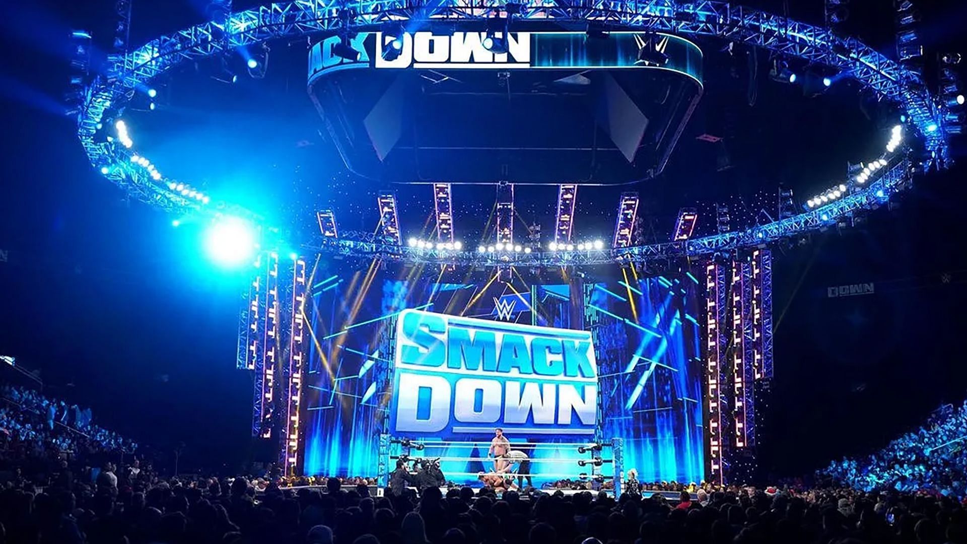 The WWE SmackDown logos and stage/ring on display inside arena