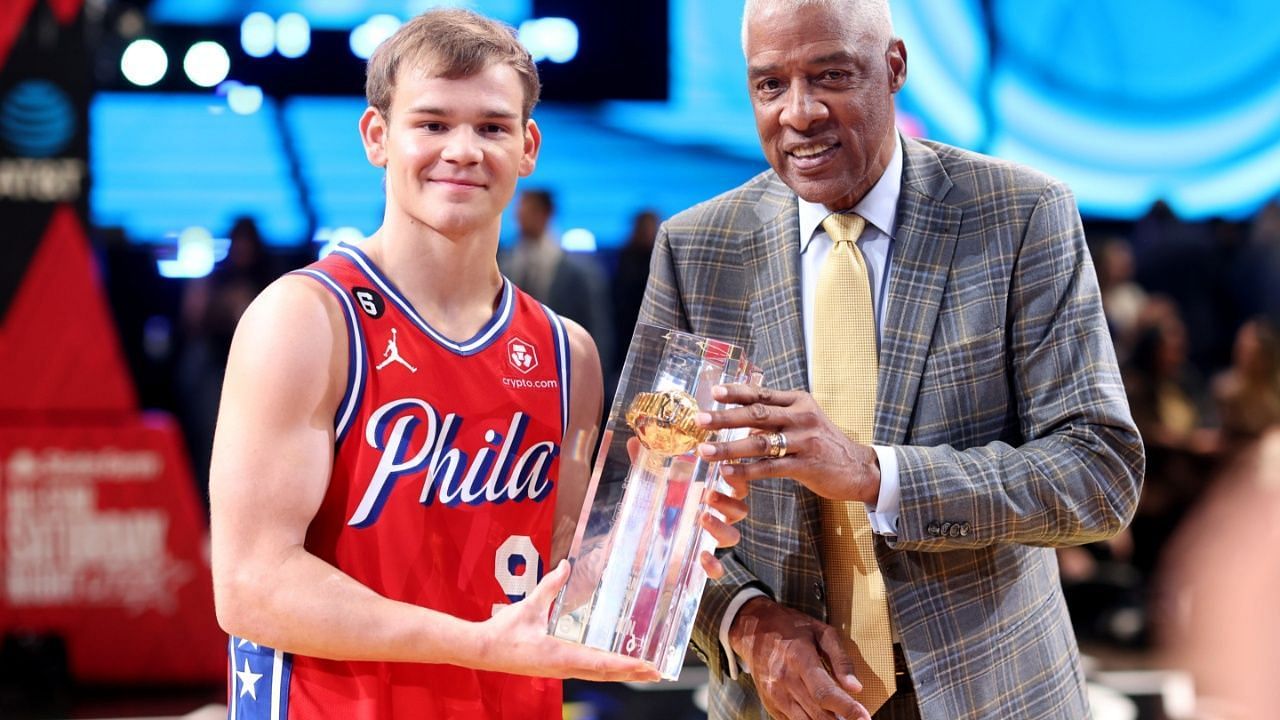 Mac McClung receiving Dunk Contest winning trophy from Dr. J.