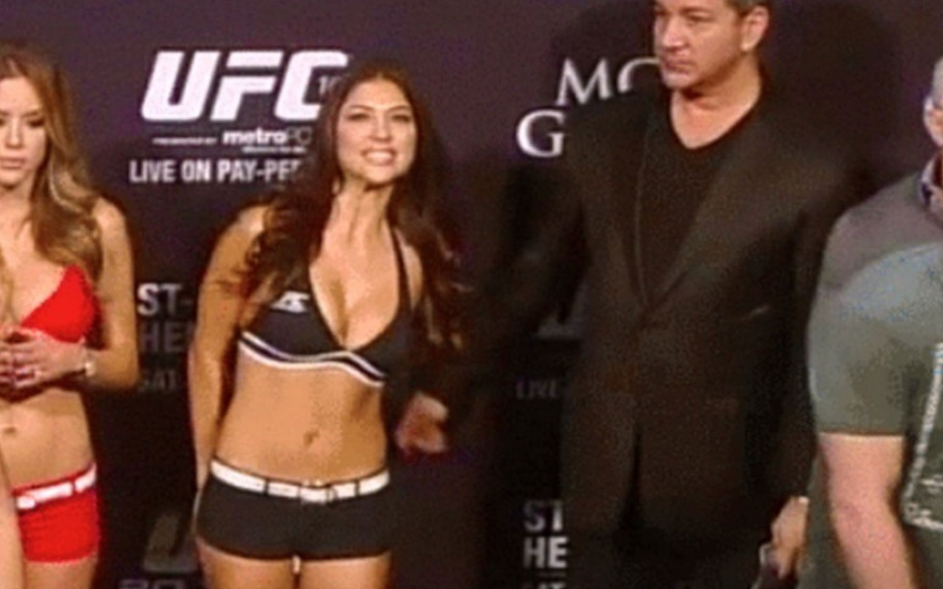 Bruce Buffer (right) tickling Arianny Celeste (left) at UFC 167 [Photo Courtesy of Bleacher Report]