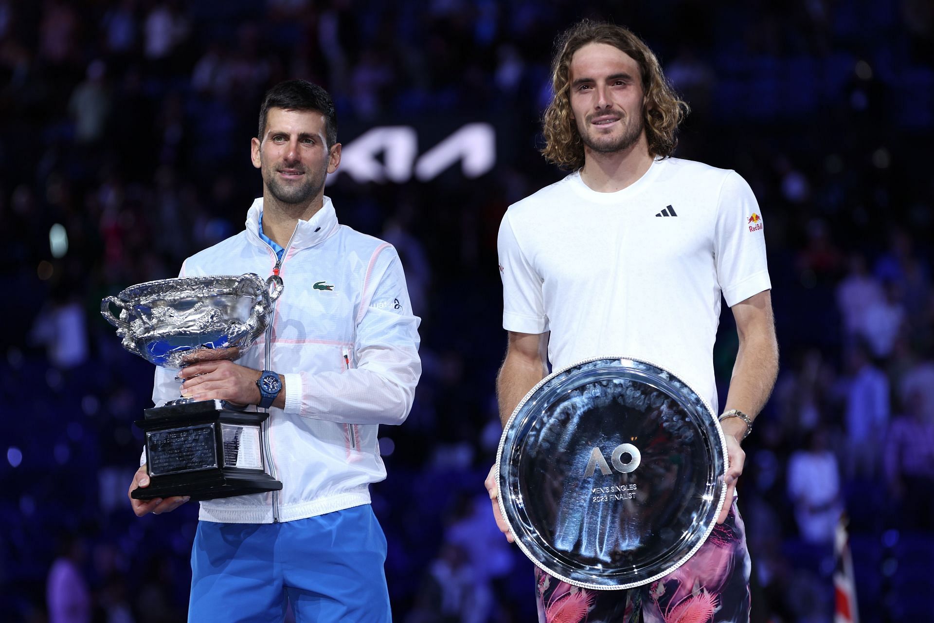 Stefanos Tsitsipas (R) pictured with his 2023 Australian Open runners-up trophy alongside champion Novak Djokovic