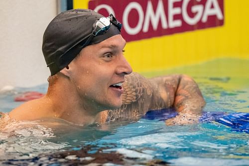 Caeleb Dressel looks on after winning the Men's 100 Meter Butterfly Final on day 3 of the Toyota US Open Championships at the Greensboro Aquatic Center in Greensboro, North Carolina.