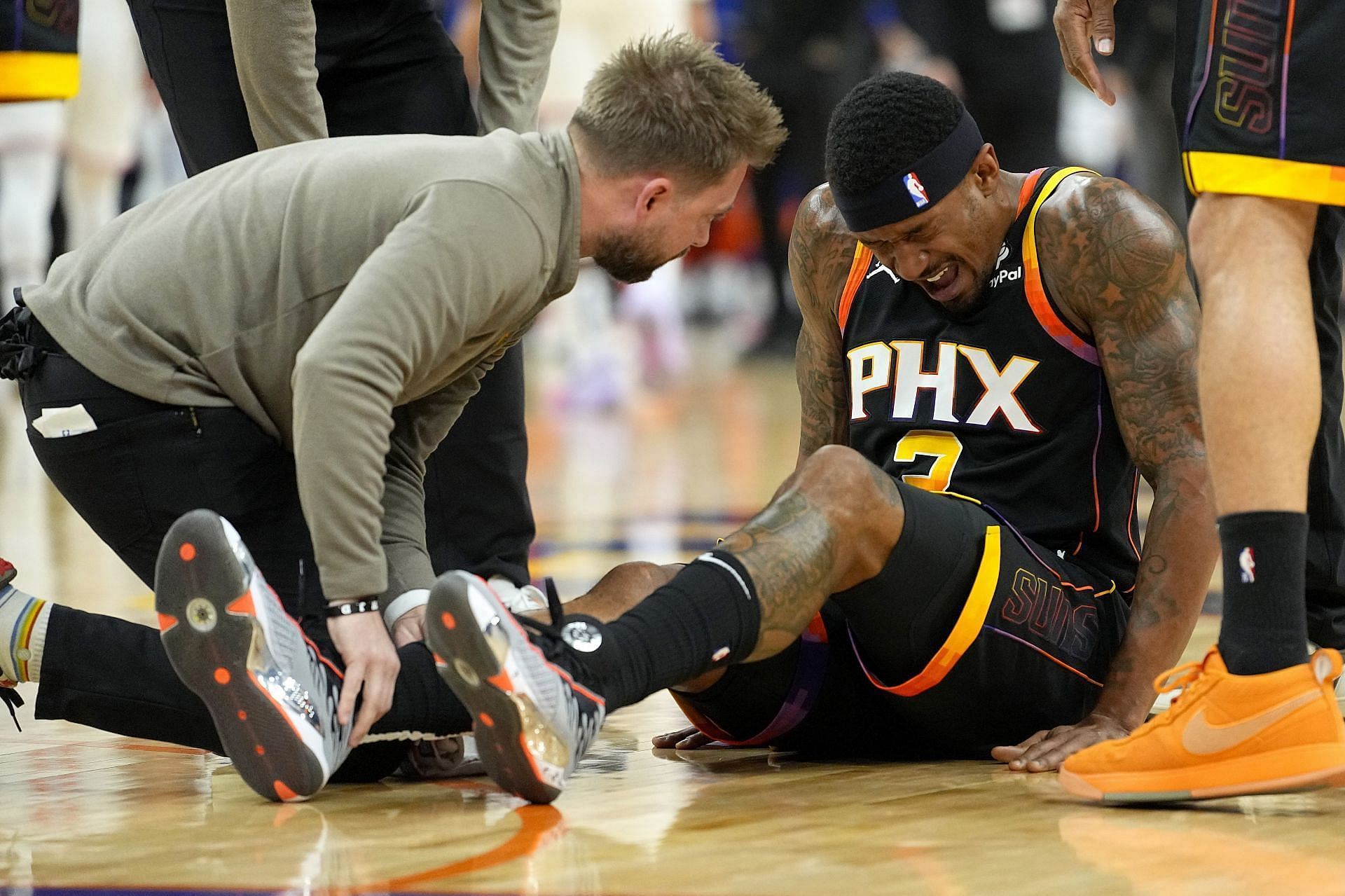 Bradley Beal grimaces in pain after spraining his ankle against the New York Knicks.