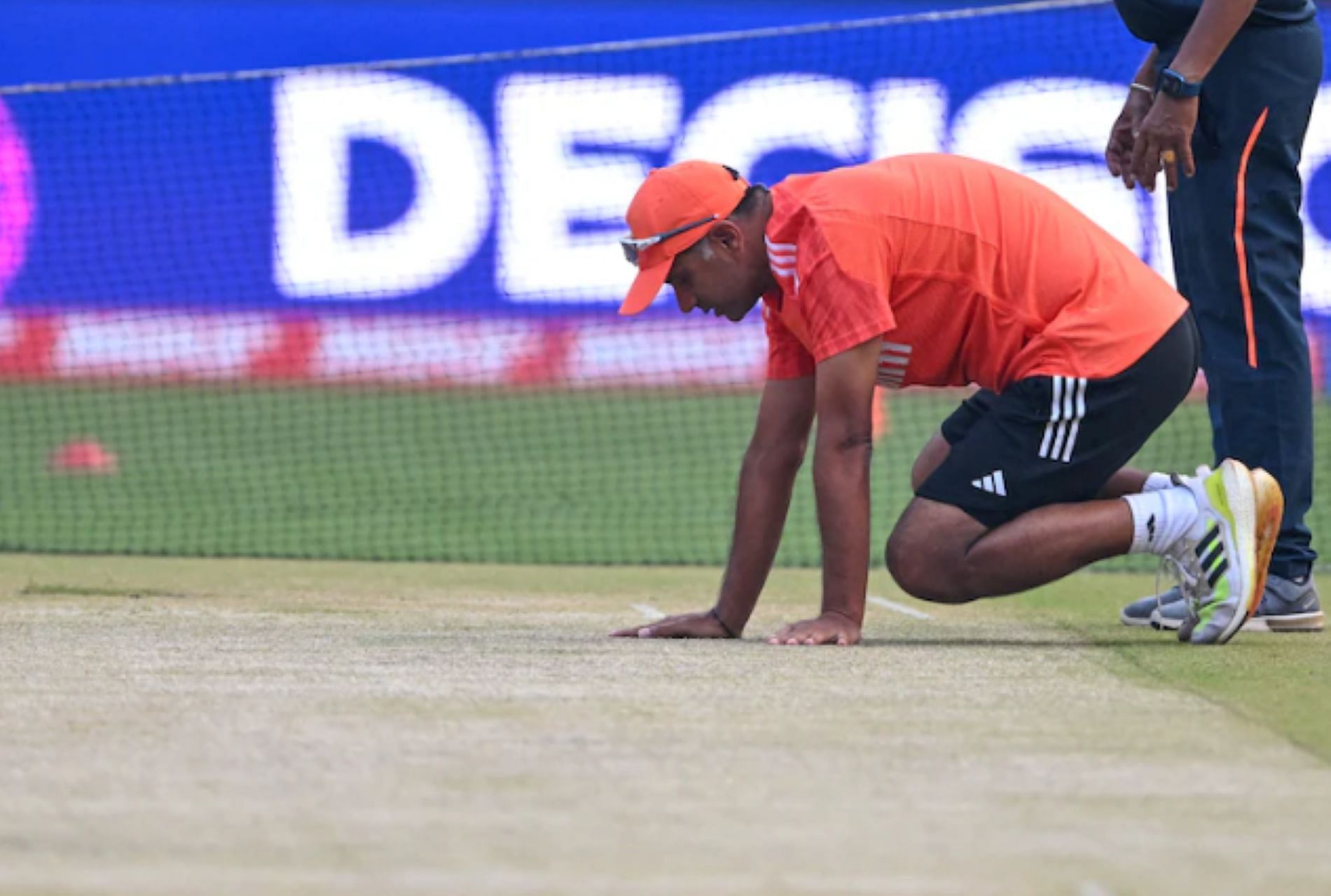 Team India head coach Rahul Dravid examines the Ahmedabad wicket ahead of the final
