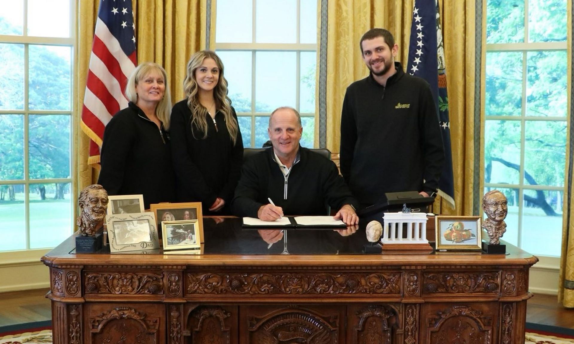 Phil Parker strikes a pose with his proud family in the iconic Oval Office at the Clinton Presidential Center, Image via X