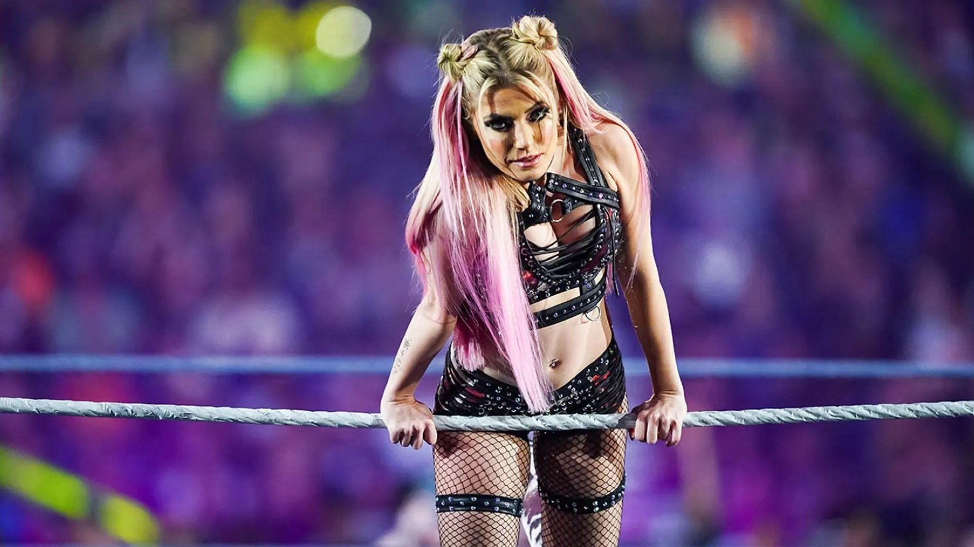 Alexa Bliss poses on the ropes for the WWE crowd