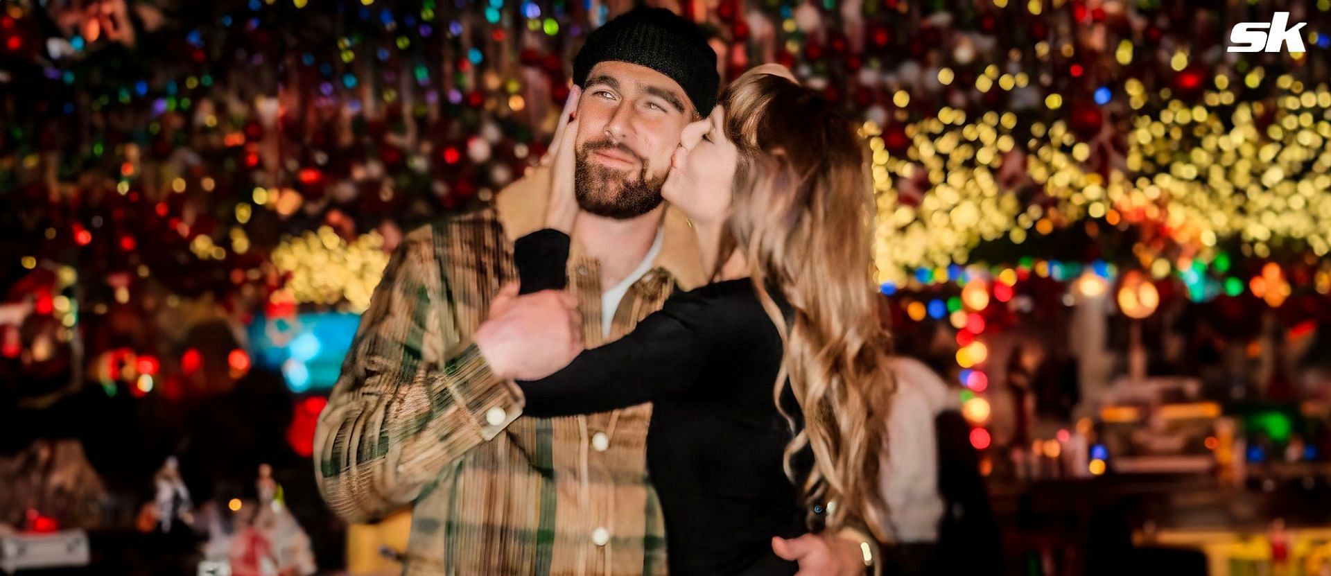 Taylor Swift kisses Travis Kelce under Christmas lights as fans take notice