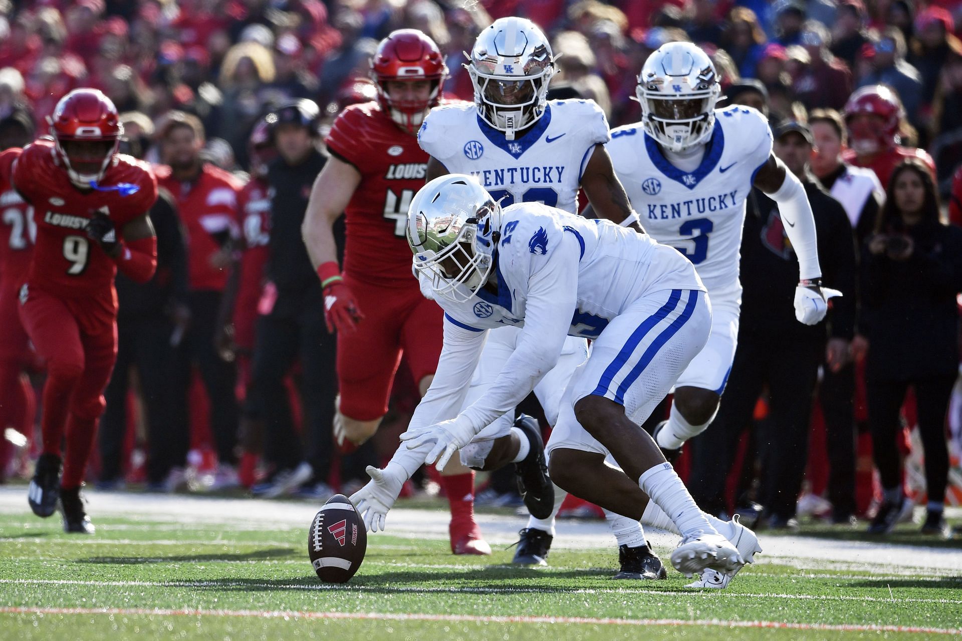 Kentucky linebacker J.J. Weaver recovers a fumble during the second half against Louisville in Louisville, Ky. on Nov. 25. Kentucky won 38-31. (AP Photo/Timothy D. Easley)