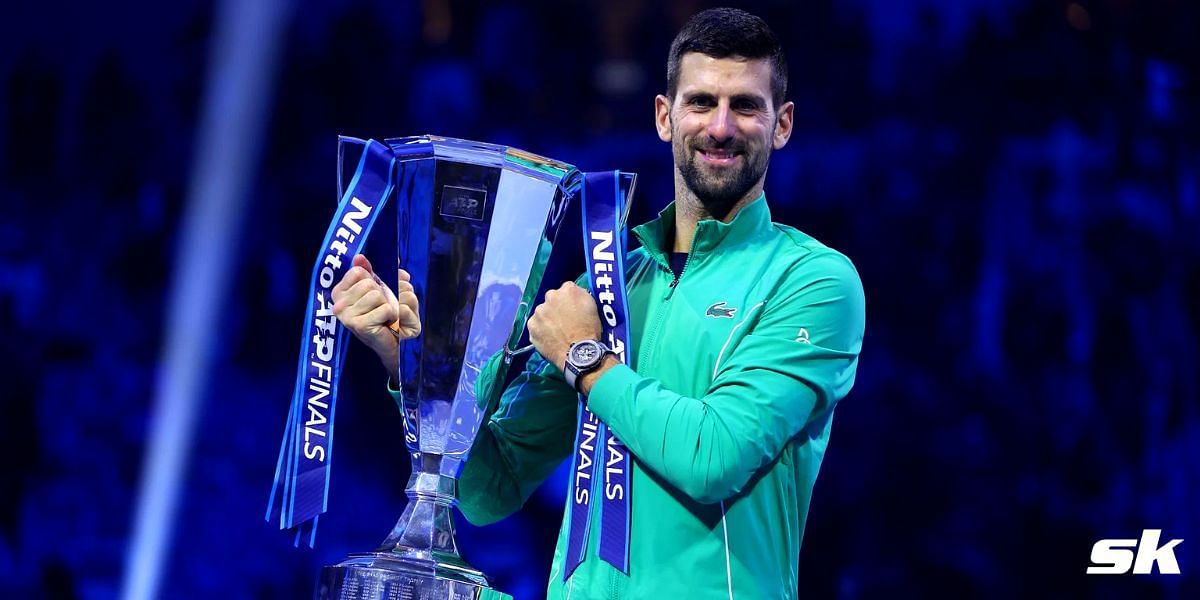 Novak Djokovic hold the 2023 ATP Finals trophy.