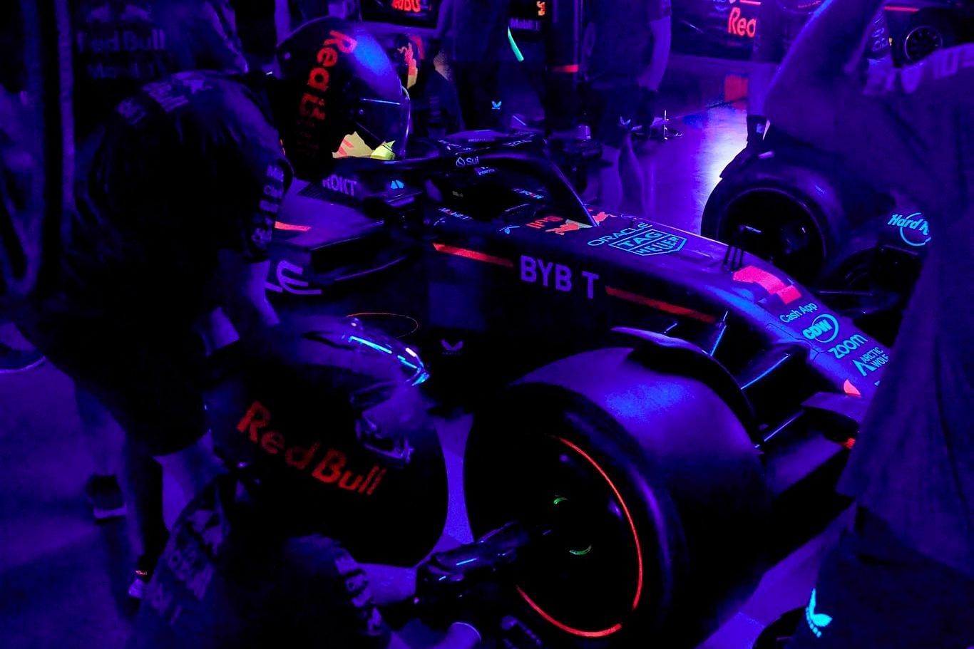 The Red Bull Racing crew performing a pit stop in pitch-black dark