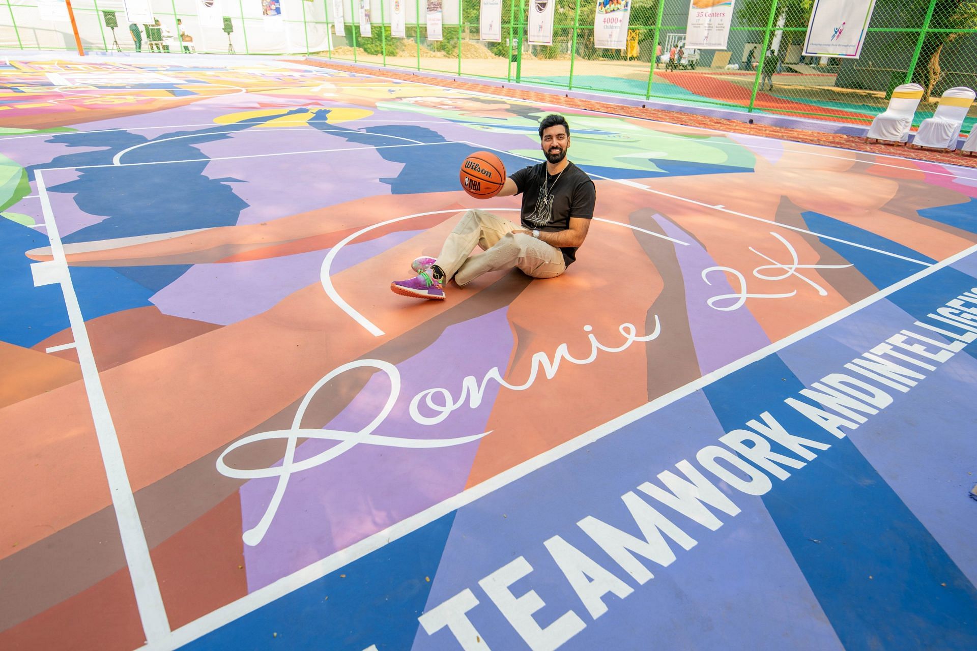 Ronnie 2K poses next to his signature on &#039;The Ronnie 2K Court&#039; (Image via: @Ronnie2K on X)