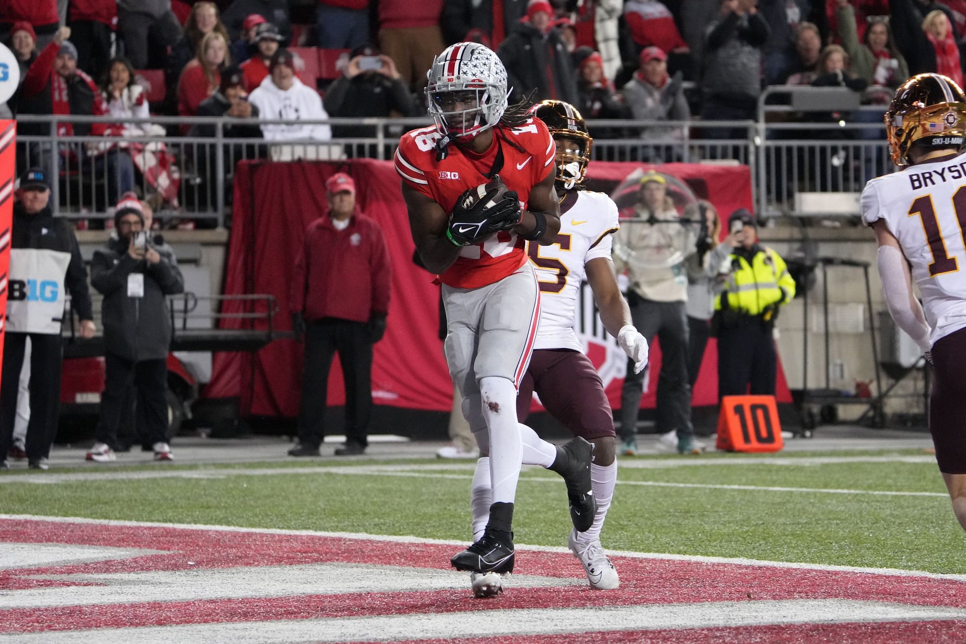 Minnesota v Ohio State: COLUMBUS, OHIO - NOVEMBER 18: Wide receiver Marvin Harrison Jr. #18 of the Ohio State Buckeyes scores a touchdown in the third quarter against the Minnesota Golden Gophers at Ohio Stadium on November 18, 2023 in Columbus, Ohio. (Photo by Jason Mowry/Getty Images)