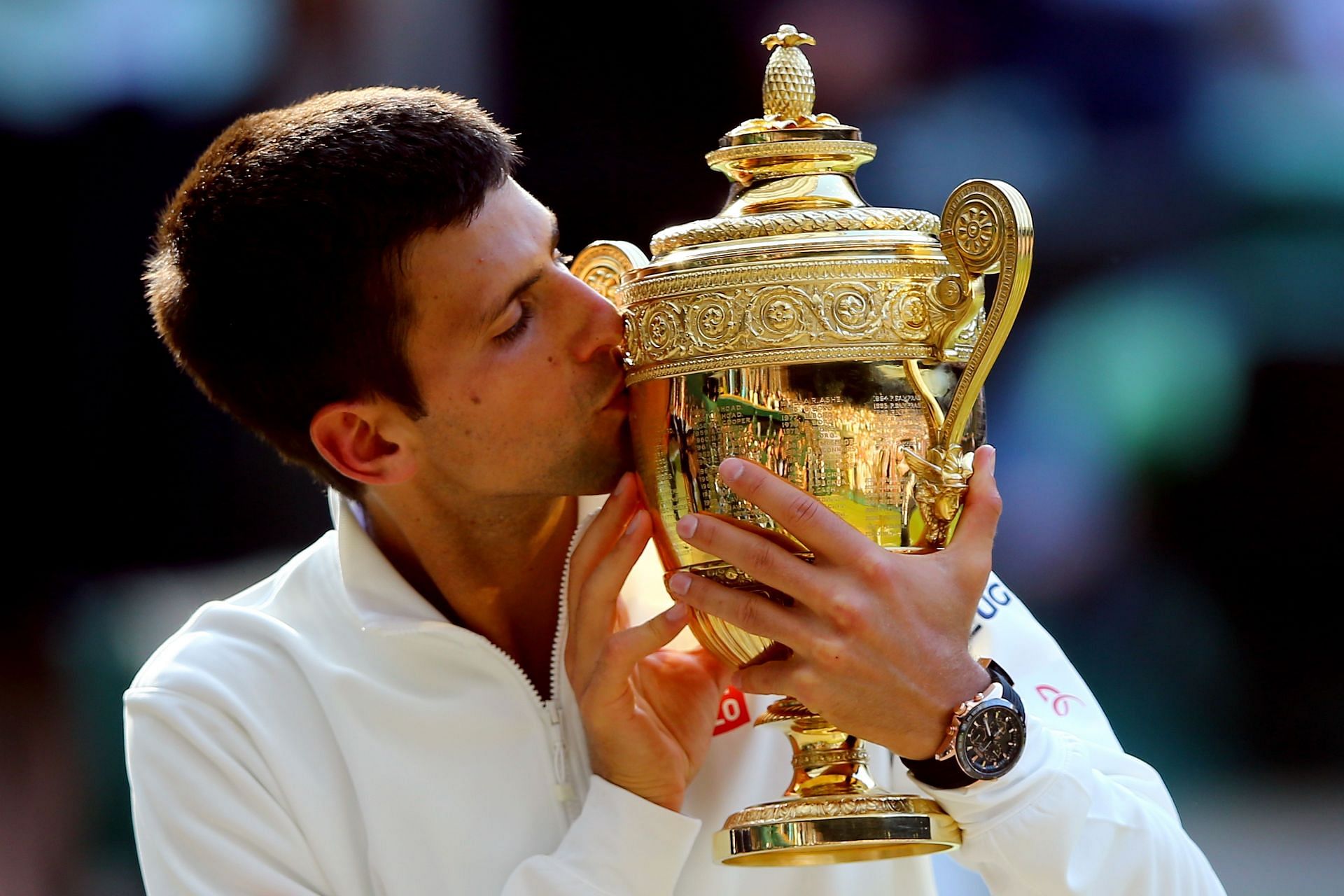 Novak Djokovic pictured kissing his second Wimbledon trophy