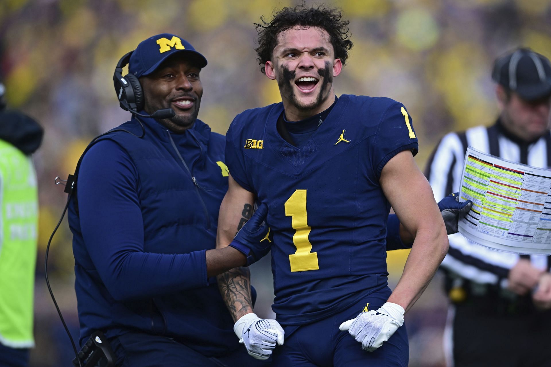 Michigan wide receiver Roman Wilson is grabbed by acting head coach Sherrone Moore after video replay confirmed his touchdown on Nov. 25 in Ann Arbor, Mich. (AP Photo/David Dermer)