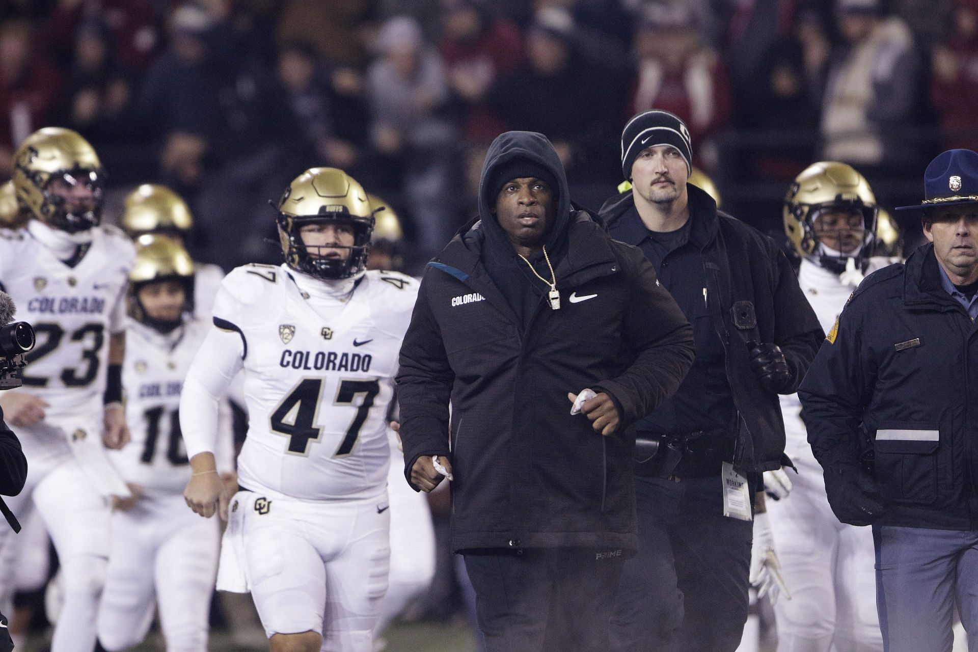 Colorado Washington St Football: Colorado coach Deion Sanders, center, runs out with the team before an NCAA college football game against Washington State, Friday, Nov. 17, 2023, in Pullman, Wash. (AP Photo/Young Kwak)