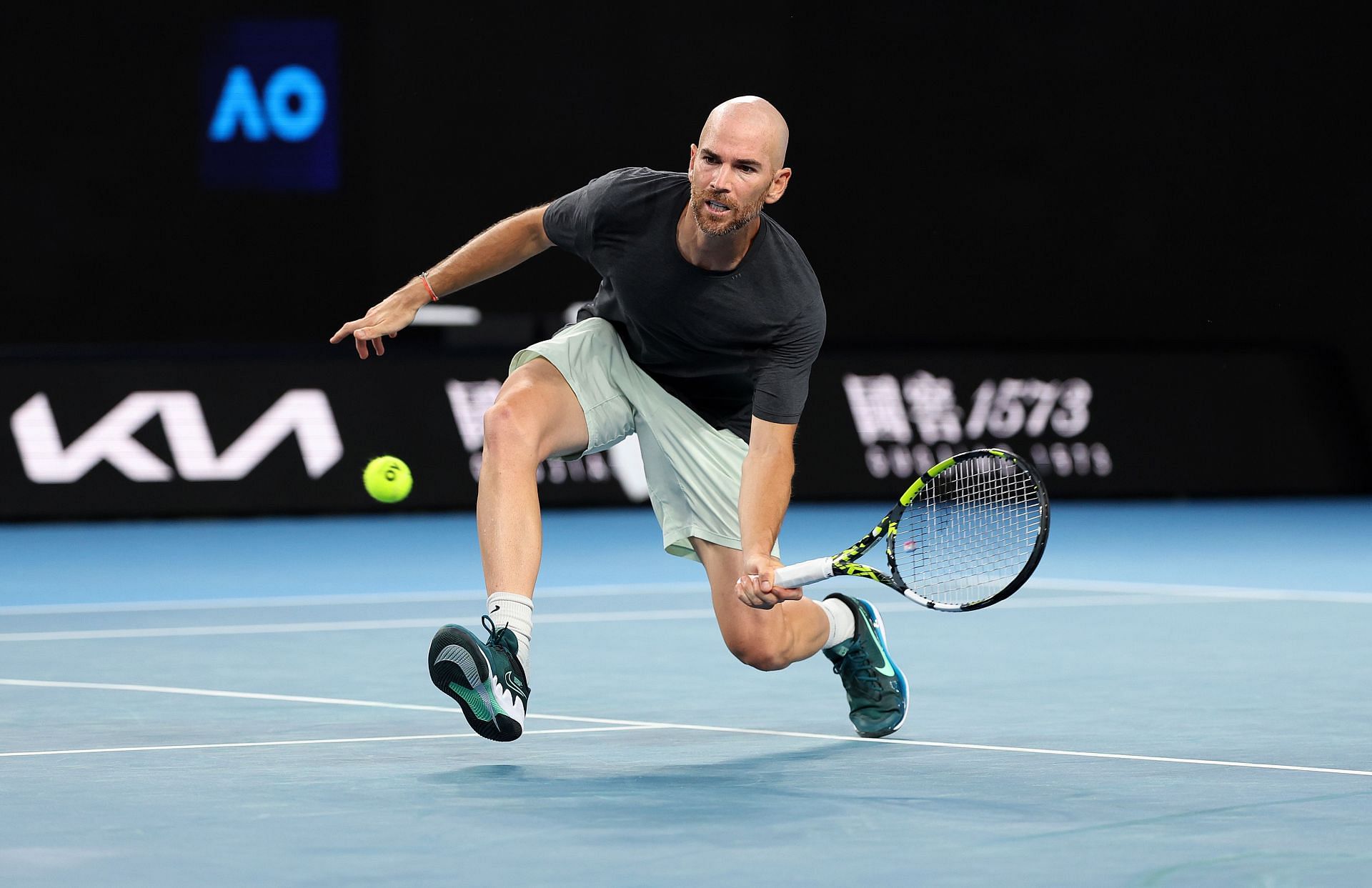 Adrian Mannarino hits a half volley at the 2024 Australian Open