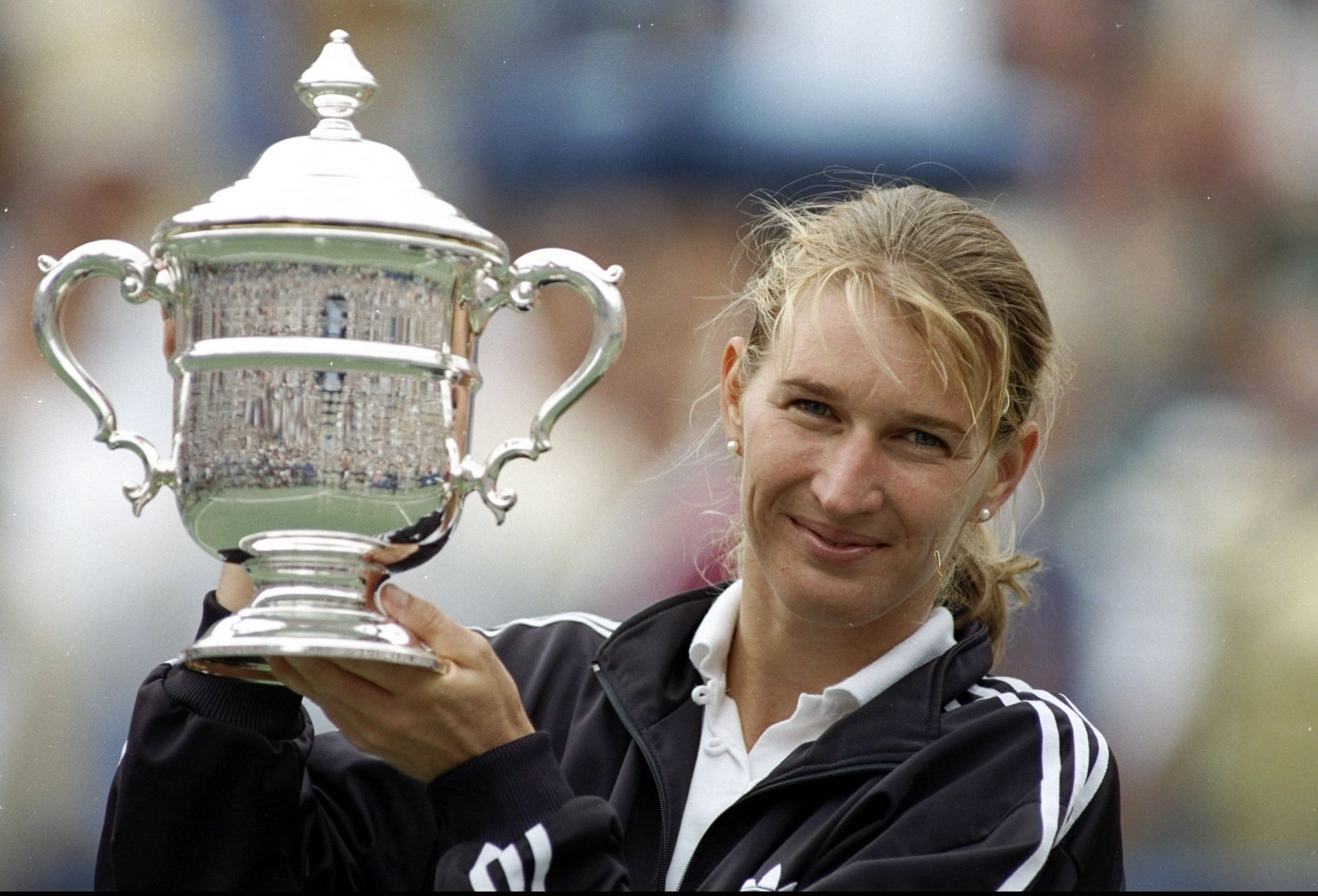 Steffi Graf poses with the US Open trophy