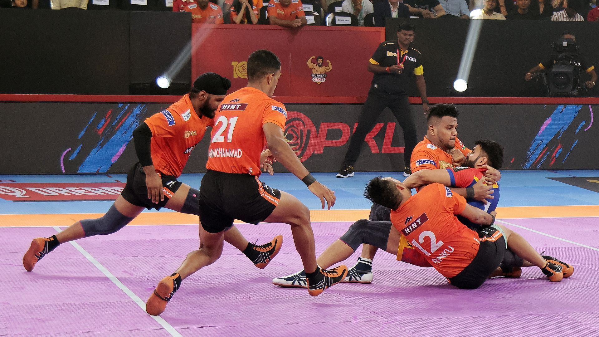 Rinku Singh in a combination tackle with Girish Aernack