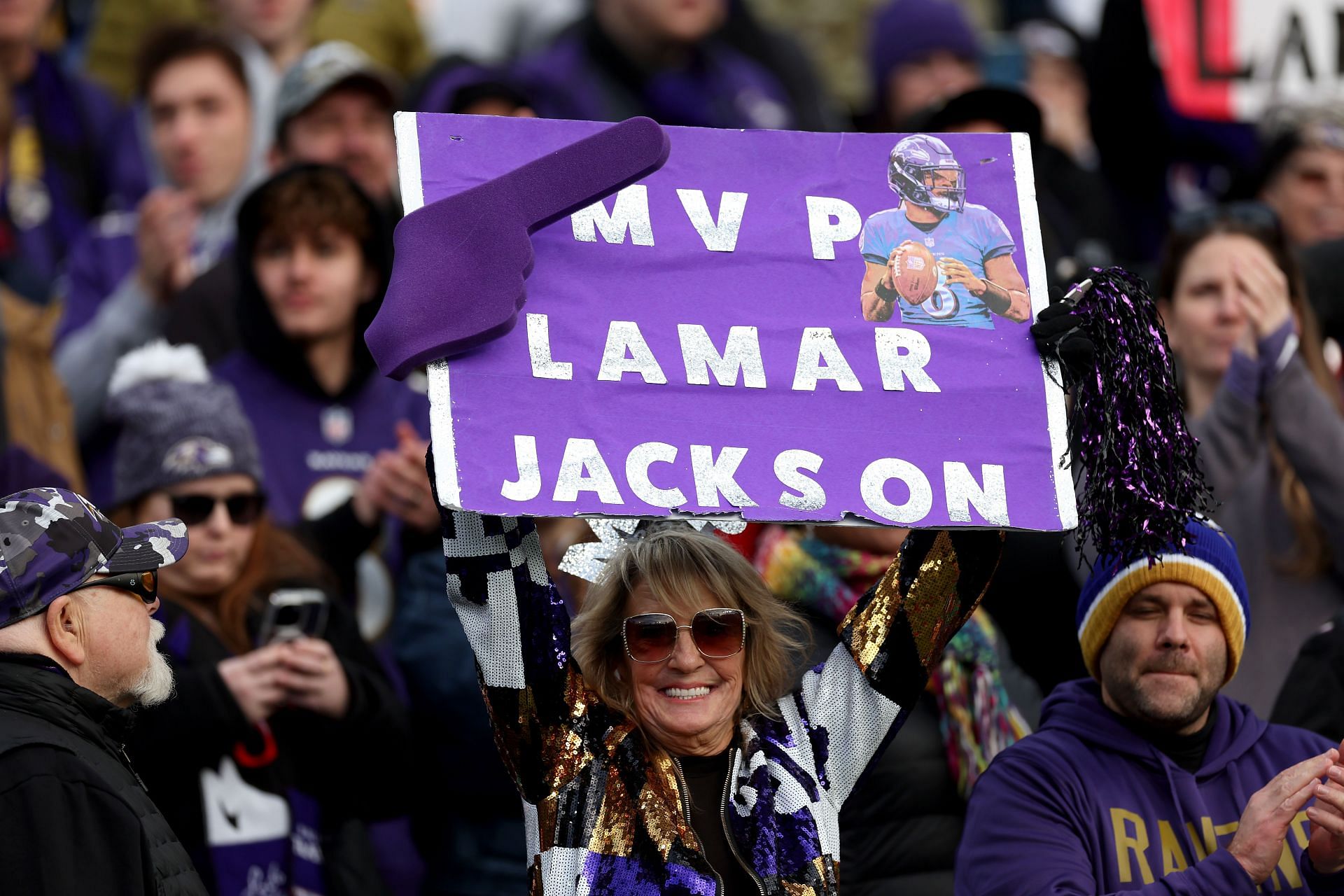 A fan holds up an MVP sign supporting quarterback Lamar Jackson