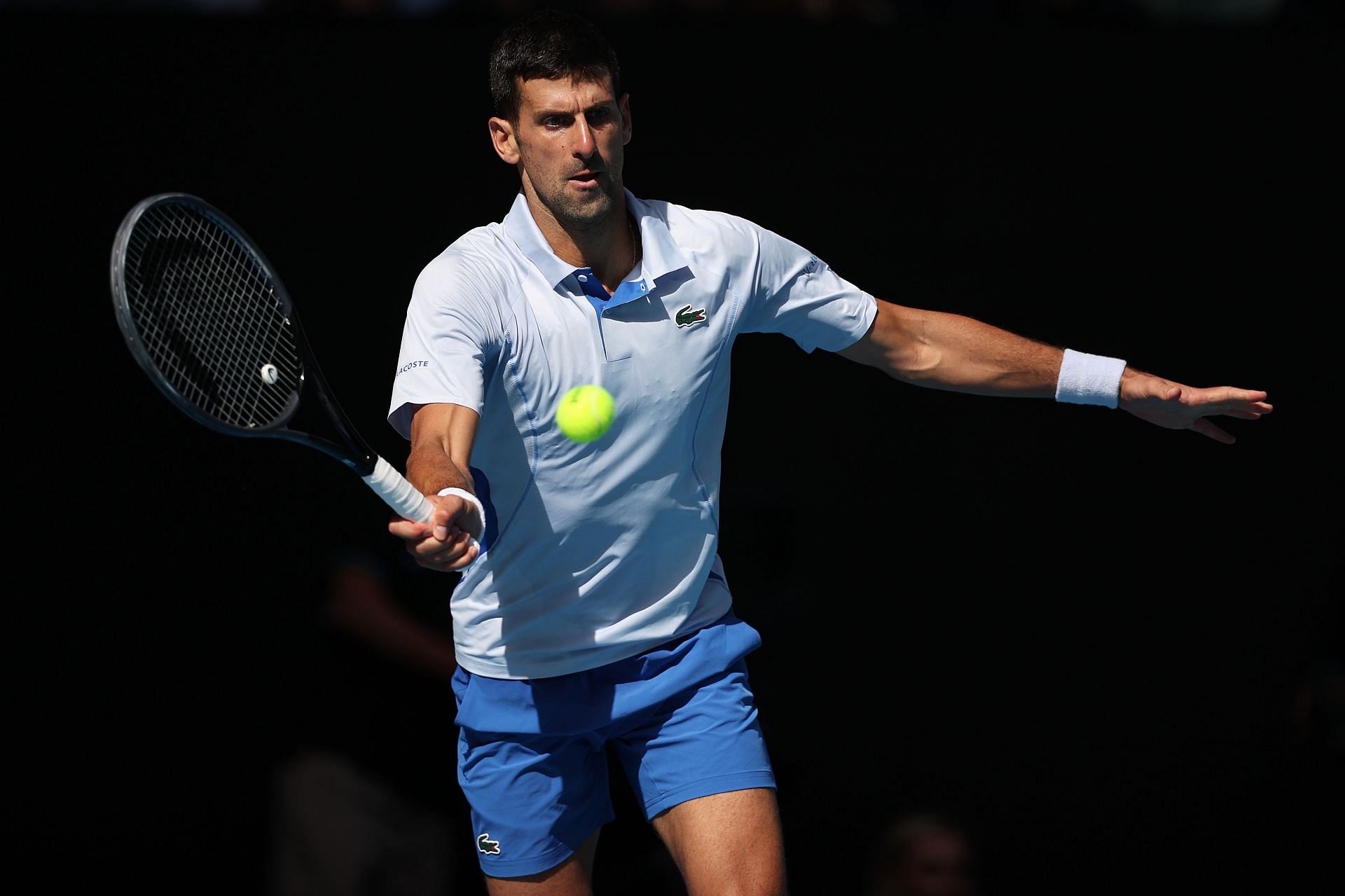 Novak Djokovic retrieves a ball at the 2024 Australian Open