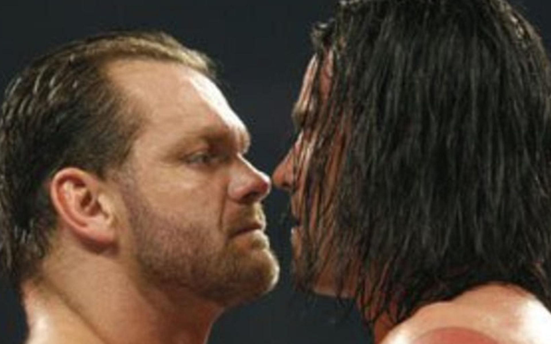 Chris Benoit and CM Punk stare one another down.