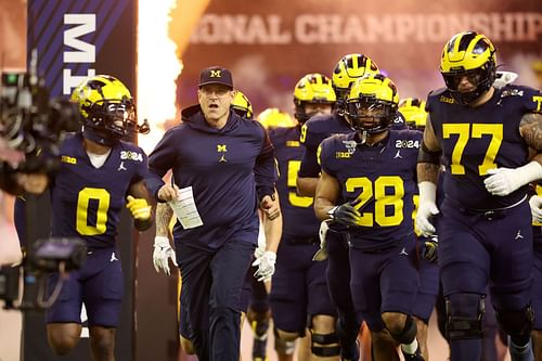 Jim Harbaugh sprints out for the National Championship Game.