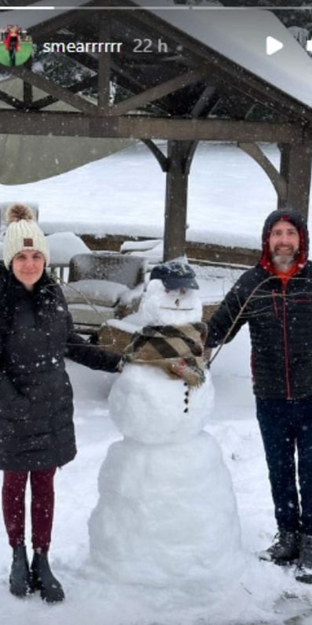 Samira and her husband Nicholas posing with the snowman.