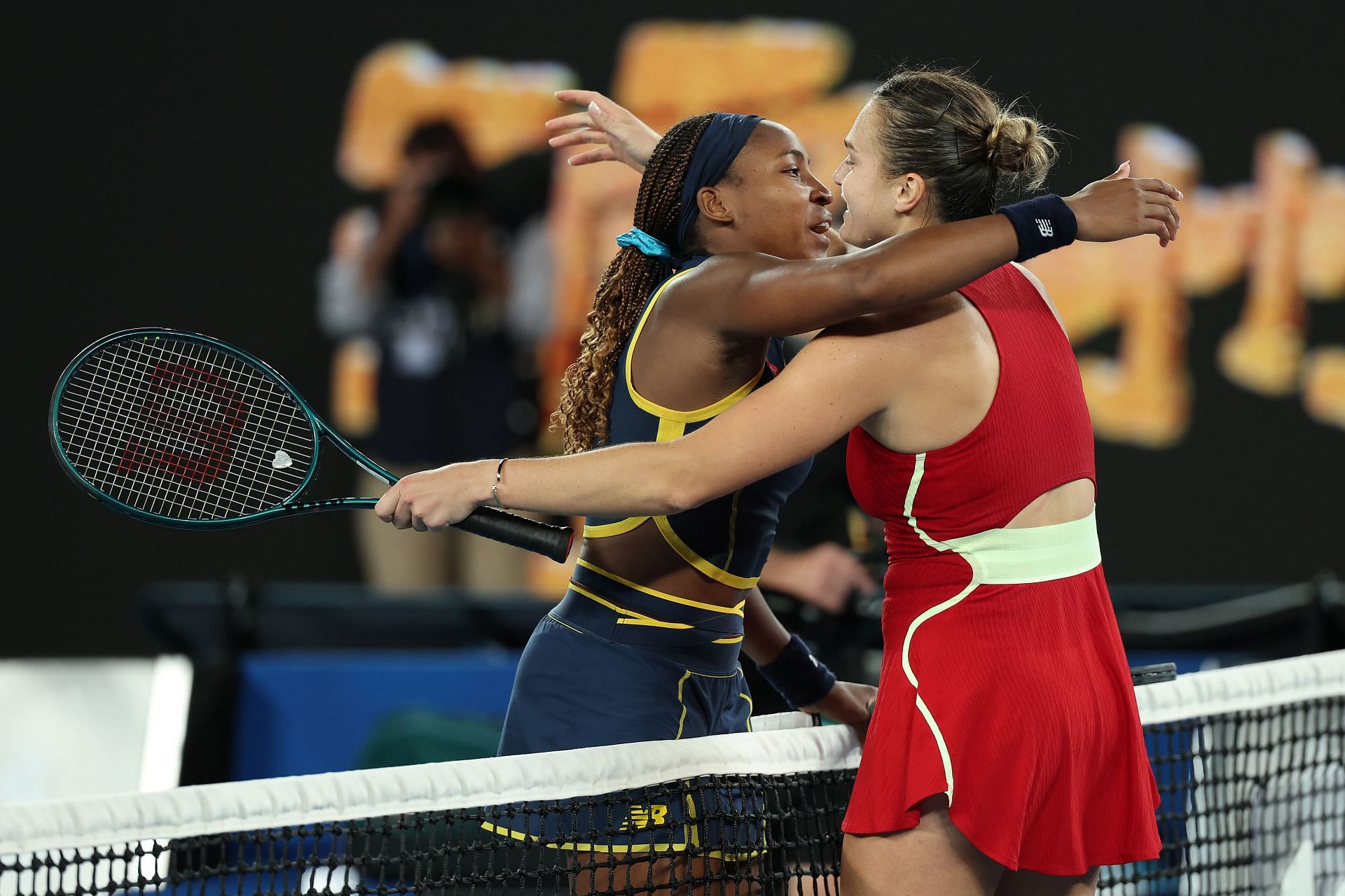 Coco Gauff (left) hugs Aryna Sabalenka at the net.