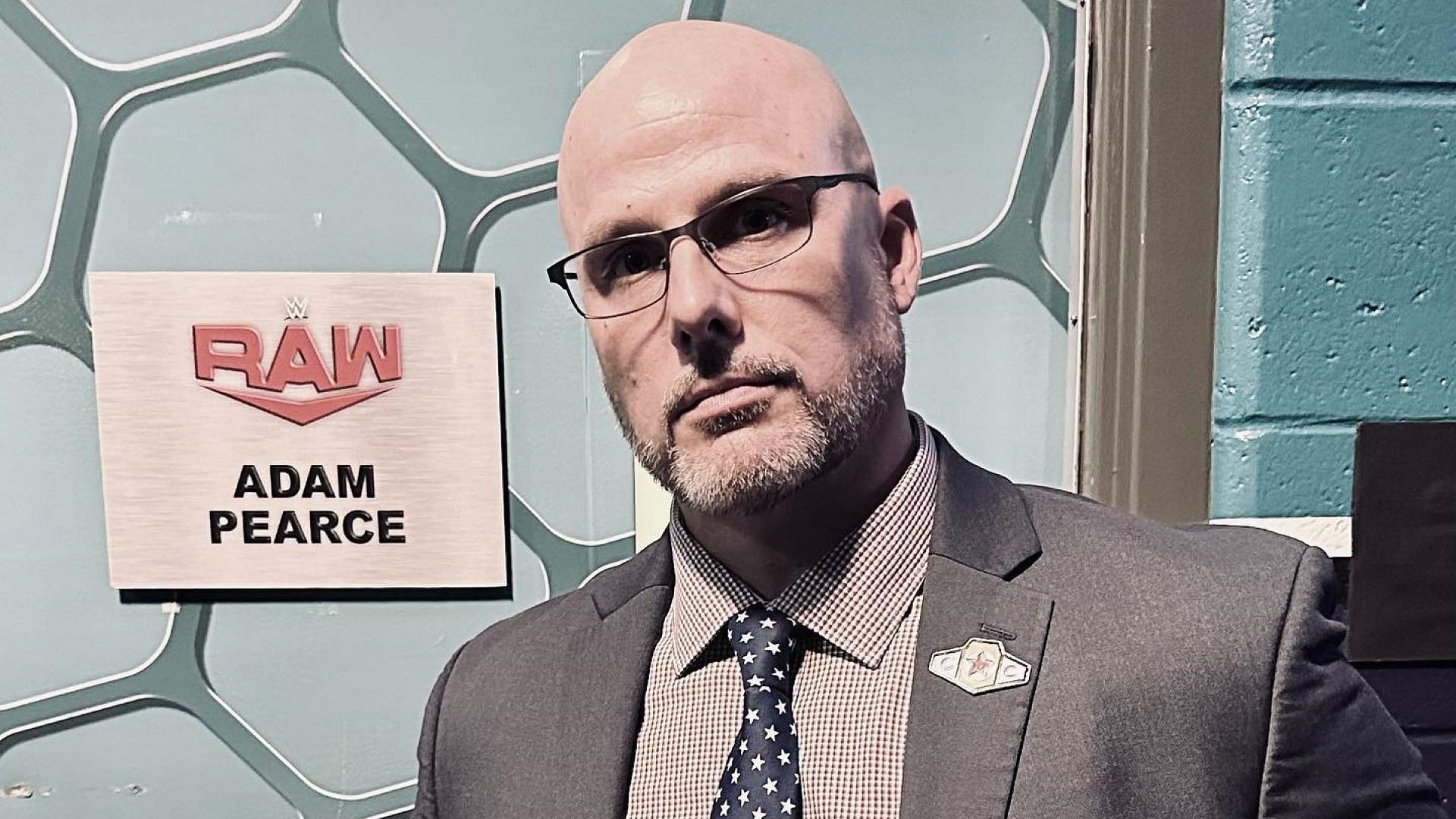 WWE RAW General Manager Adam Pearce in front of his backstage office