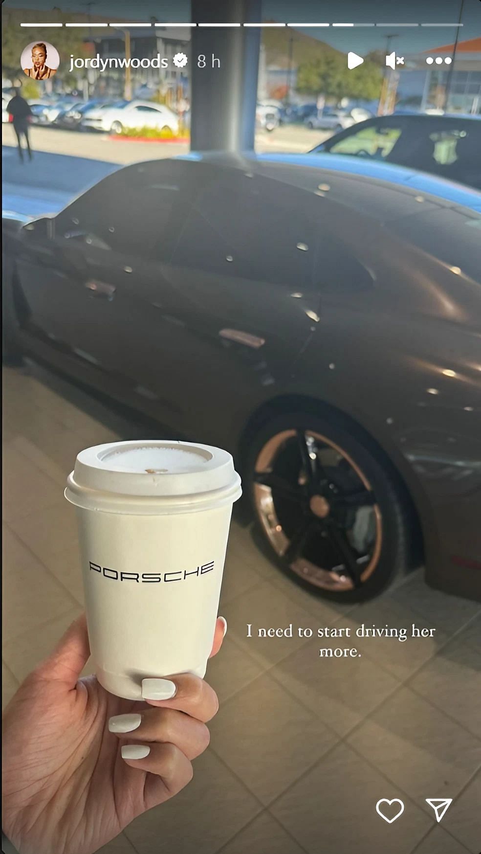 Jordyn Woods showing her Porsche Taycan