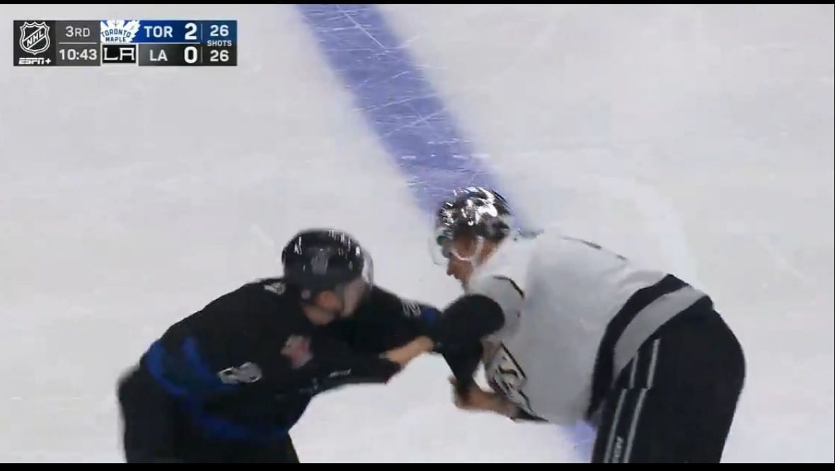 Andreas Englund and Simon Benoit chuck knuckles during Kings vs Leafs clash