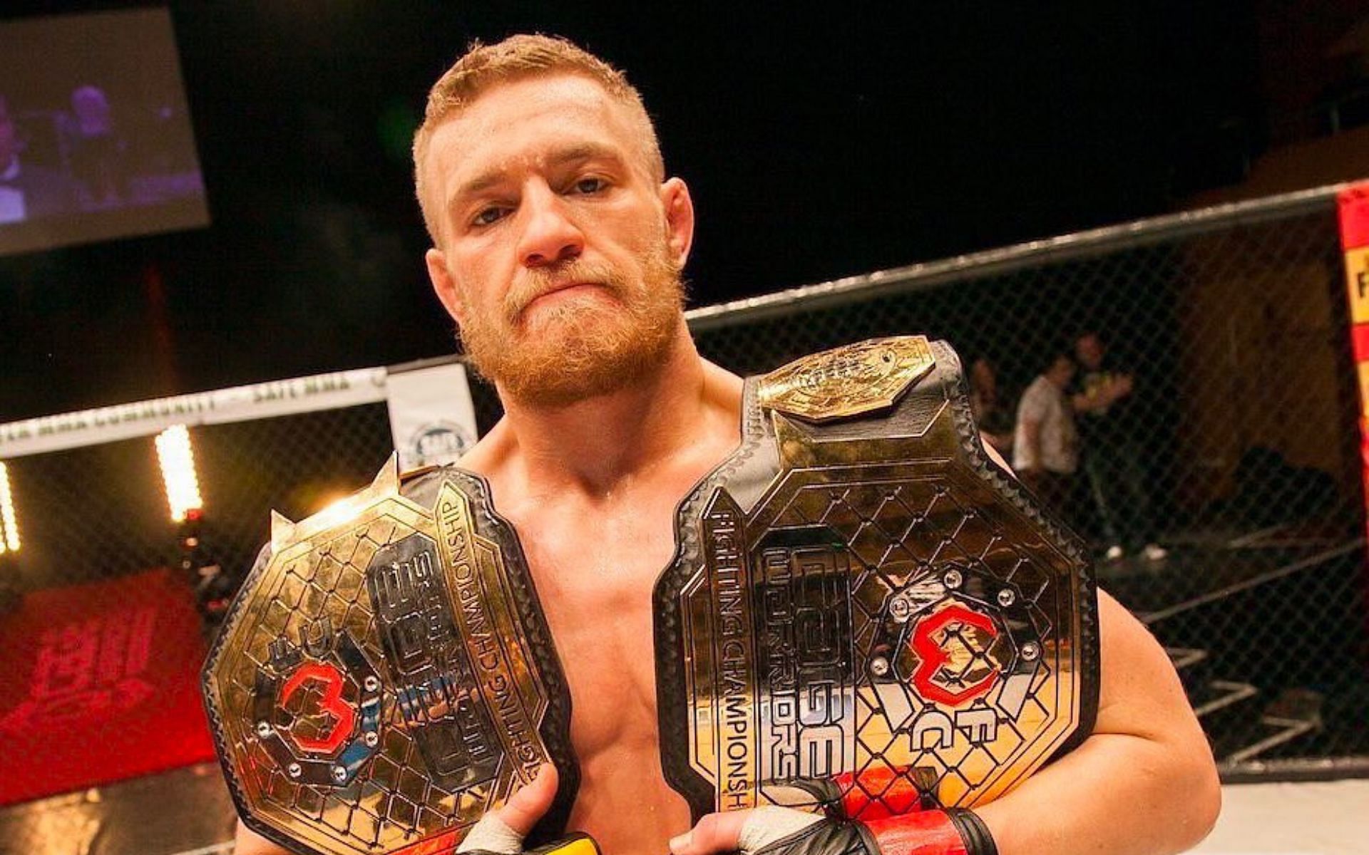 Conor McGregor holding his two Cage Warrior belts (Image courtesy @thenotoriousmma on Instagram)