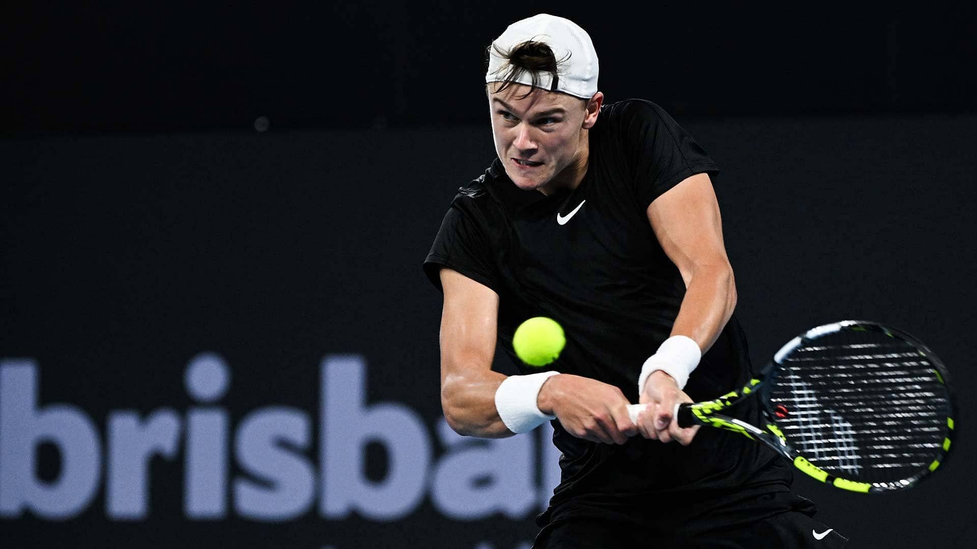 The Danish 20-year-old hits a backhand in Brisbane