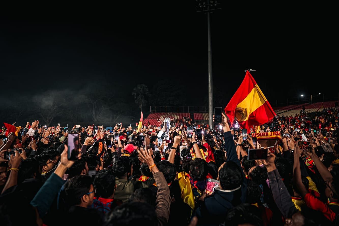 East Bengal fans celebrating with the Super Cup trophy at the club ground.